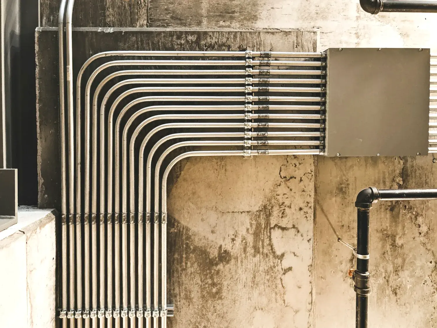 Installed pipe runs on a commercial wall